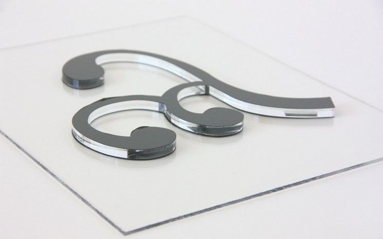 Laser cut acrylic with grey adhesive vinyl face movie set prop