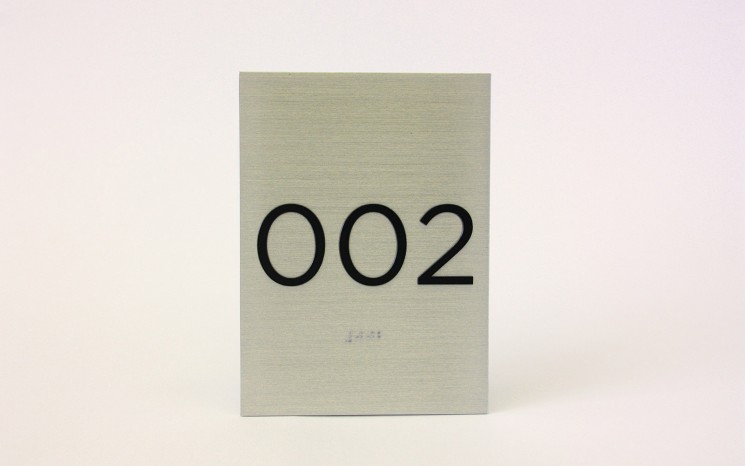 Tactile lettering and raster bead braille brushed aluminum ADA sign