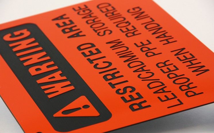 Laser engraved plastic warning directional sign