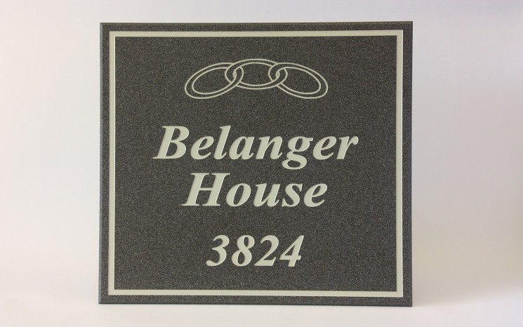 Engraved Corian white paint in-filled wayfinder/directional sign