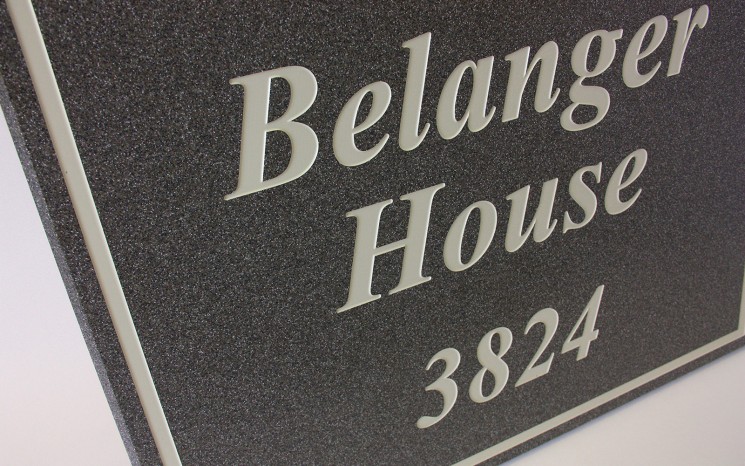 Engraved Corian white paint in-filled wayfinder/directional sign