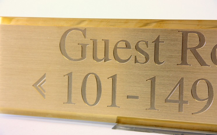 Engraved brush faced brass wayfinder/directional sign