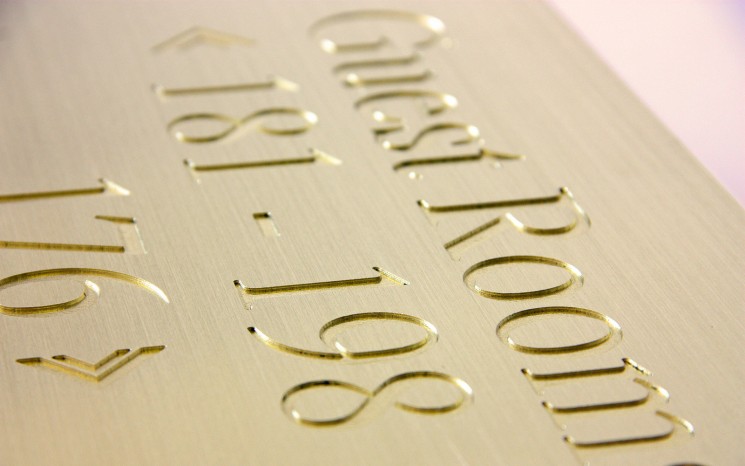 Engraved brush faced brass wayfinder/directional sign