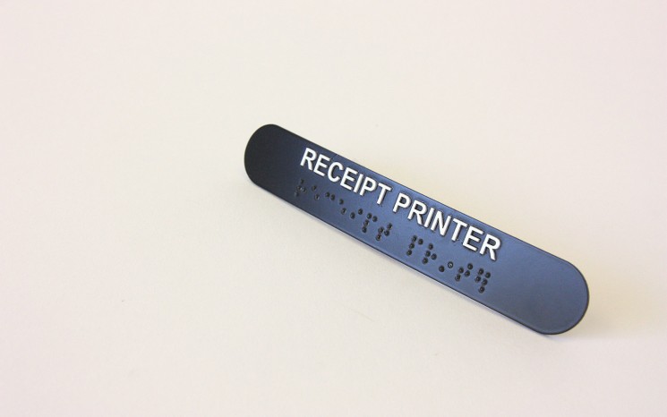 Raised tactile lettering and bead braille wayfinder/directional sign