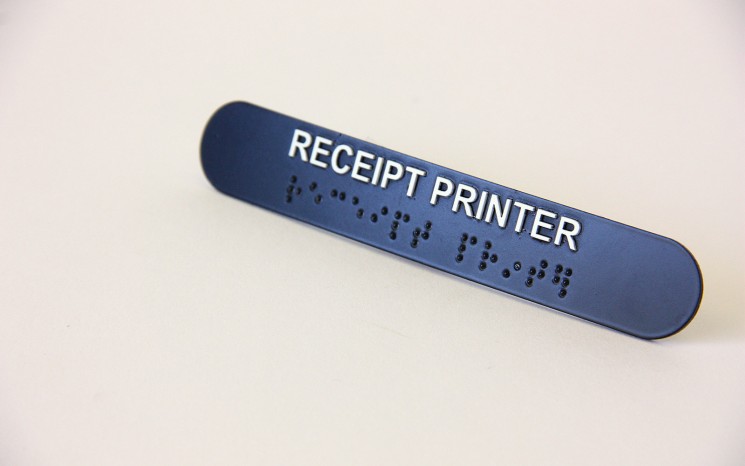 Raised tactile lettering and bead braille wayfinder/directional sign