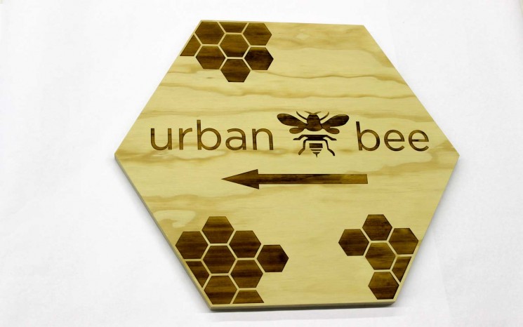 Wayfinder sign with laser etched graphics on exterior grade plywood