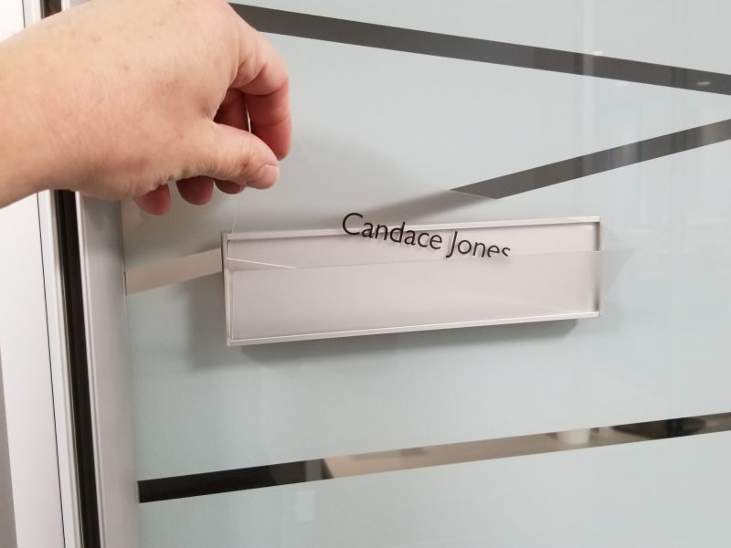 Changeable VSF60-8.5L Flat Office Nameplate installed on glass with messaged insert Candace