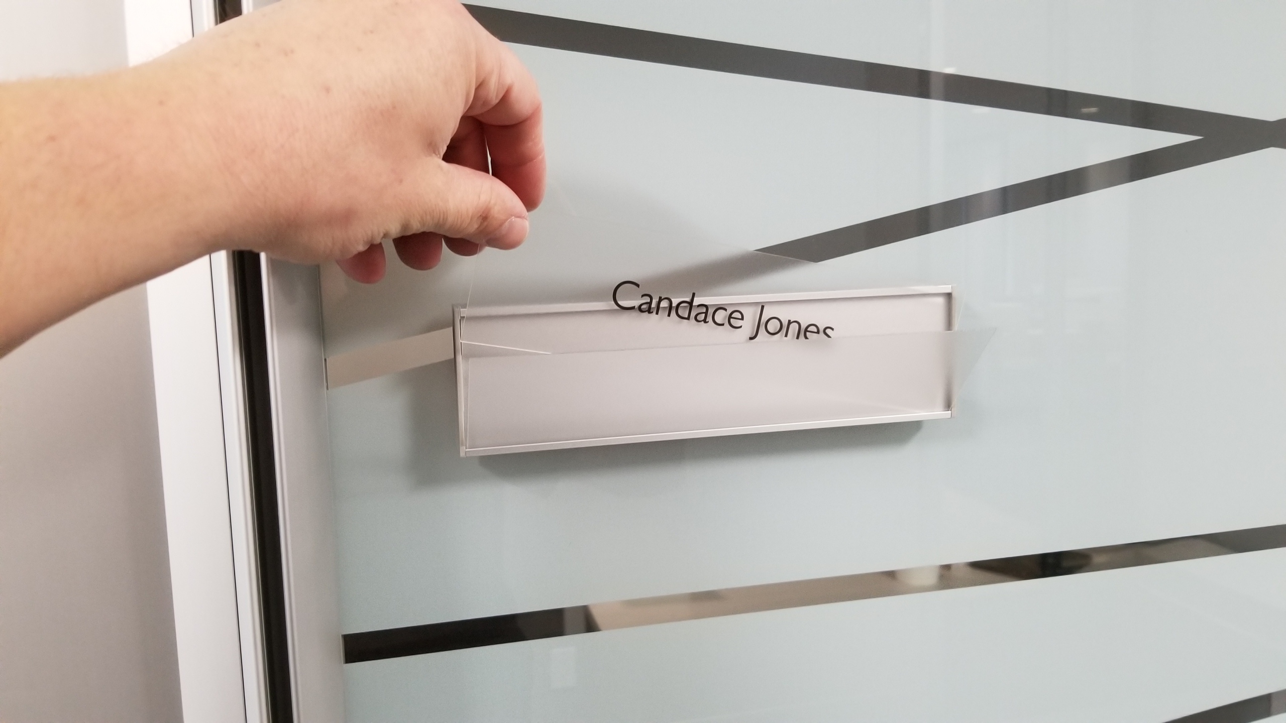 Changeable VSF60-8.5L Flat Office Nameplate installed on glass with messaged insert Candace